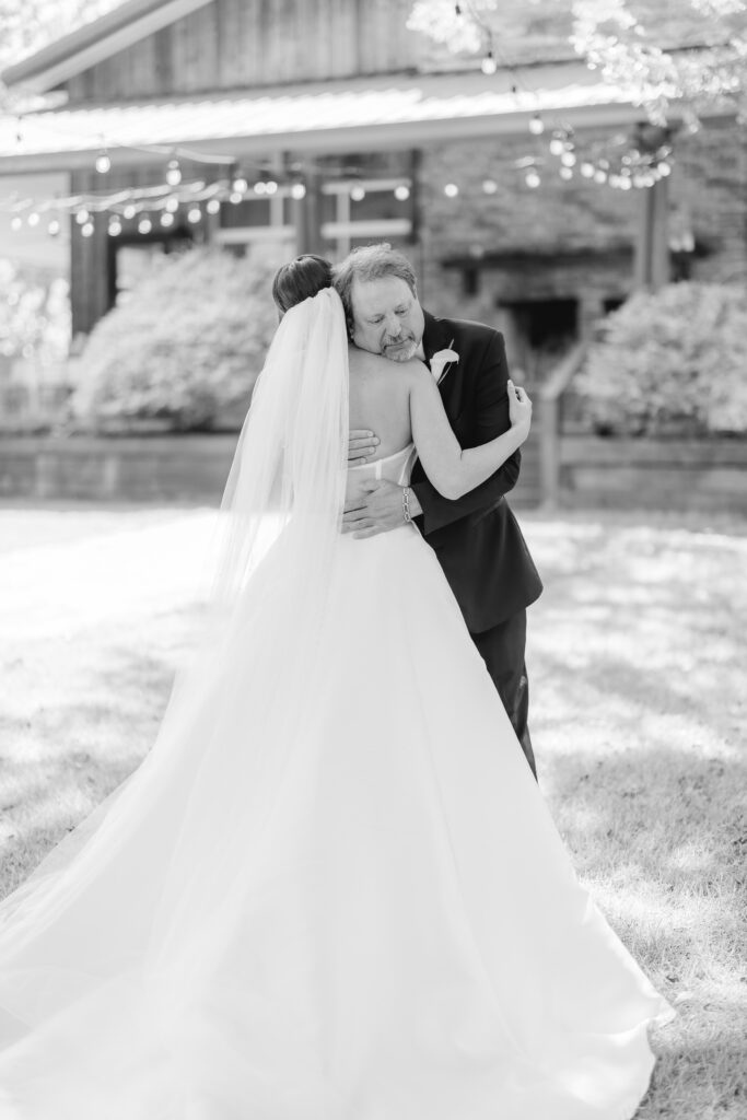 Abby sharing an emotional first look with her dad on her wedding day.