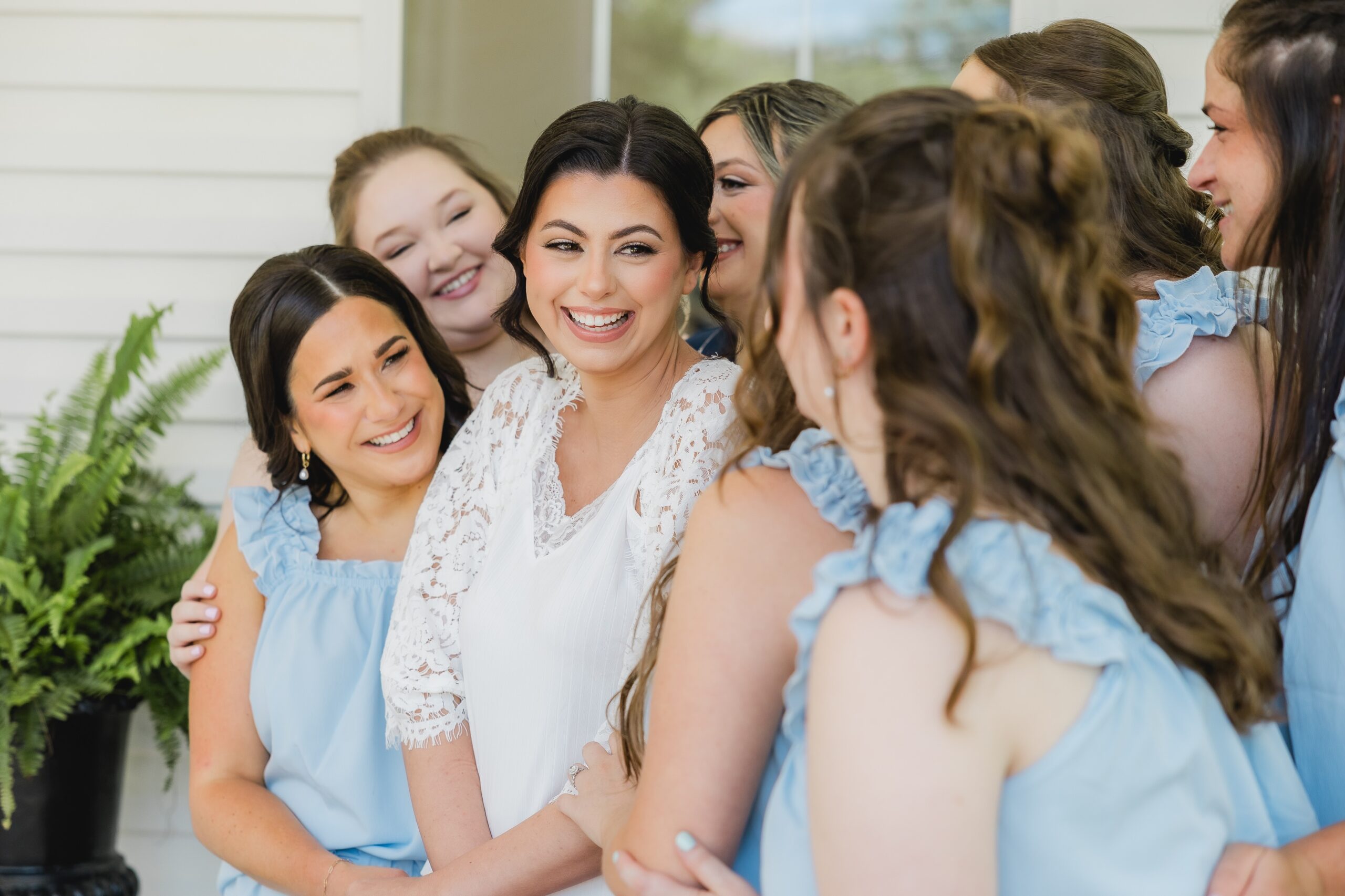Abby and her bridesmaids laughing together in their pajamas before the wedding.