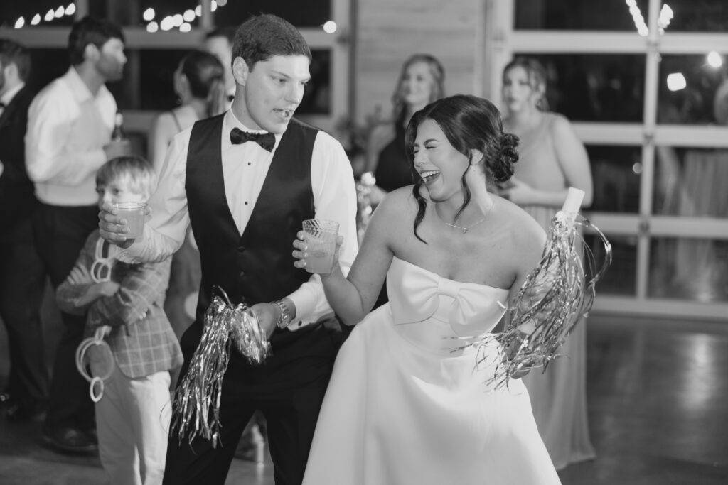 Abby and Jonathan laughing together during their wedding reception.