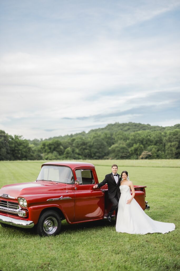 Abby and Jonathan posing beside Jonathan’s uncle’s vintage red pickup truck.