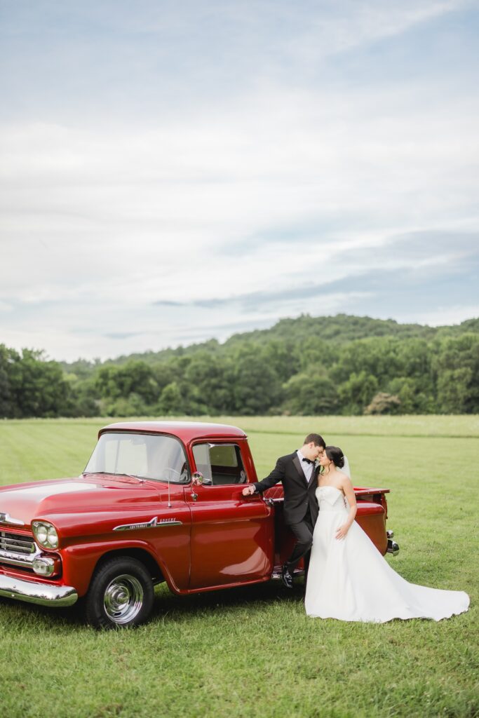 Abby and Jonathan posing beside Jonathan’s uncle’s vintage red pickup truck.