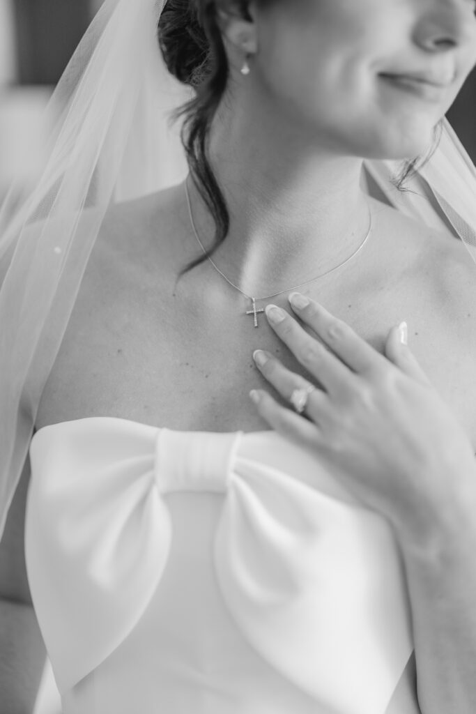 Wedding rings and neckalce photographed among Abby and Jonathan’s wedding details.