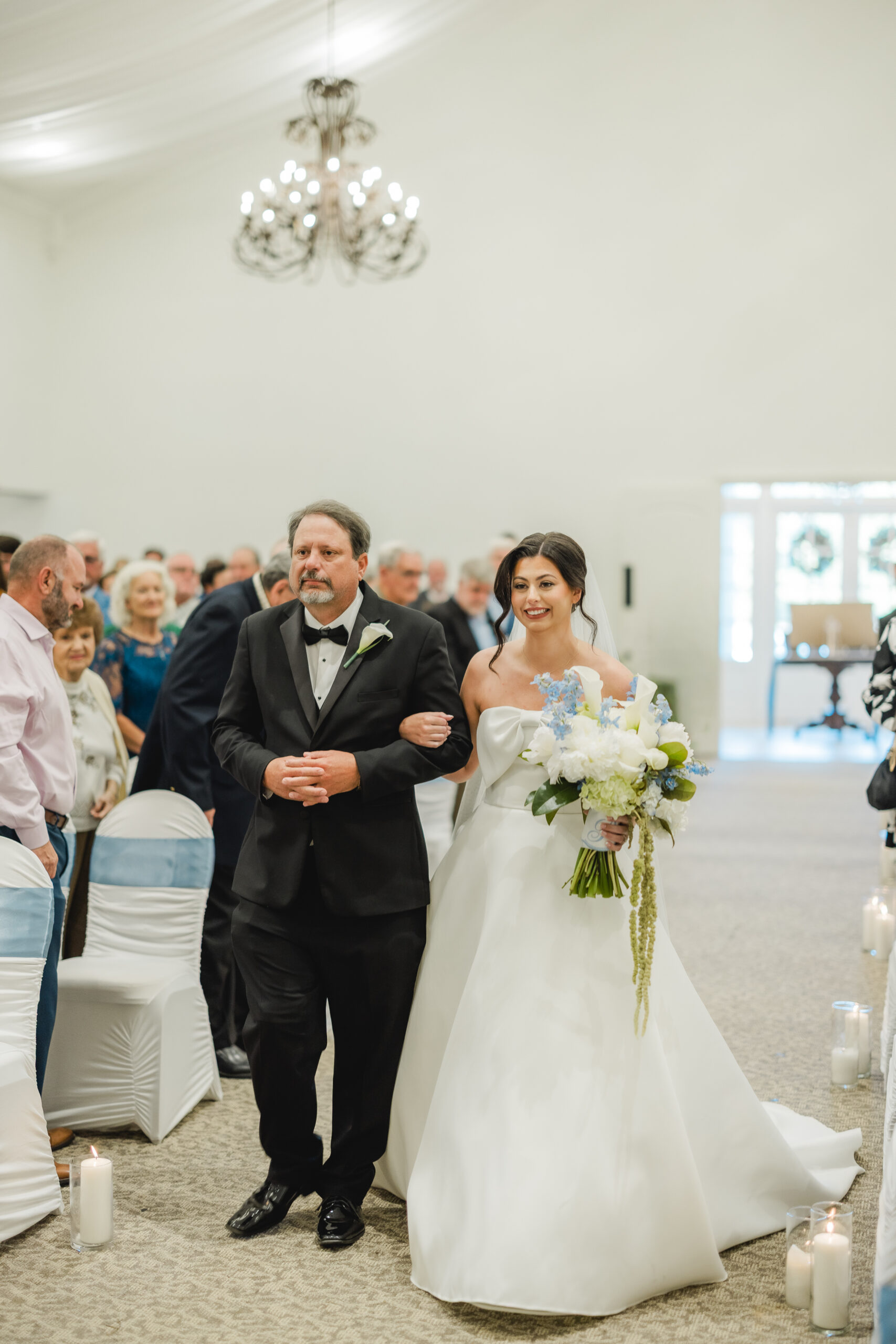 Abby walking down the aisle toward Jonathan on their wedding day.