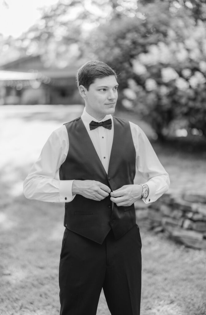 Jonathan adjusting his suit before seeing Abby for their first look.