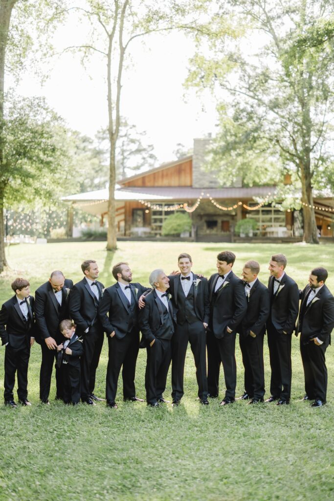 Jonathan's groomsmen laughing together for a wedding-day portrait.