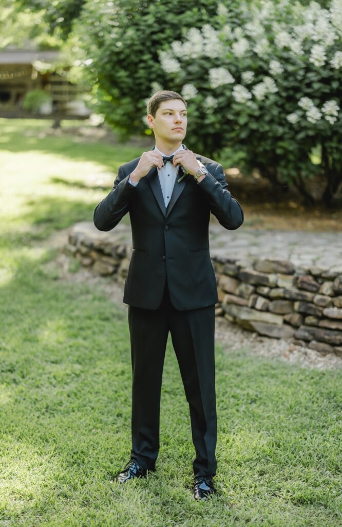 Jonathan adjusting his suit before seeing Abby for their first look.